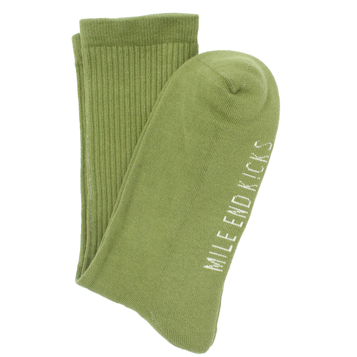 Green socks with 'Mile End Kicks' branding on a white background