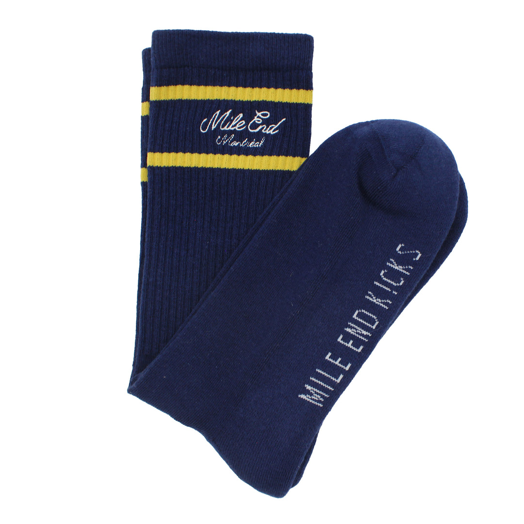 Pair of navy blue socks with yellow stripes and 'Mile End Kicks' branding on a white background