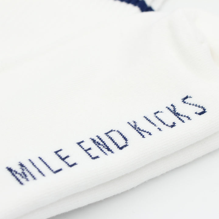 White sock with 'MILE END KICKS' text in blue on a white background