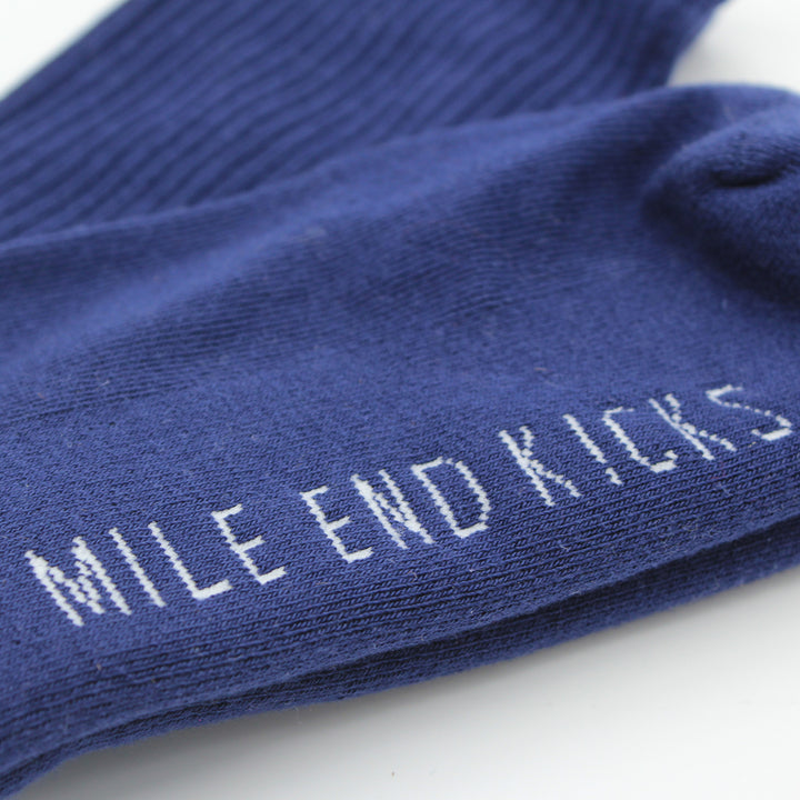 Blue socks with 'Mile End Kicks' text on a white background