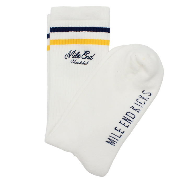 White socks with yellow and blue accents and 'Mile End Kicks' branding on a white background