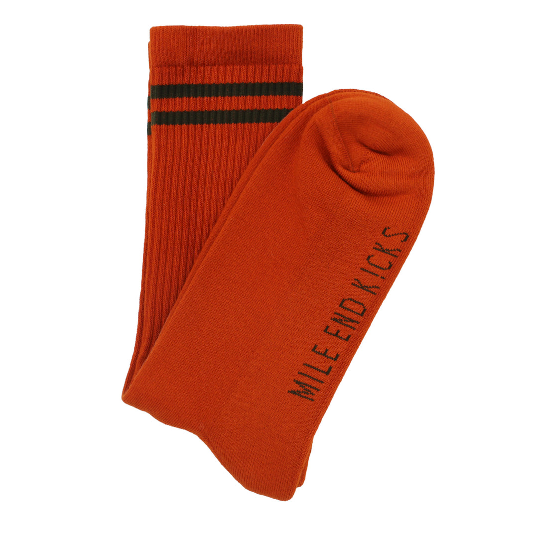 Orange sock with green text and two green stripes on a white background