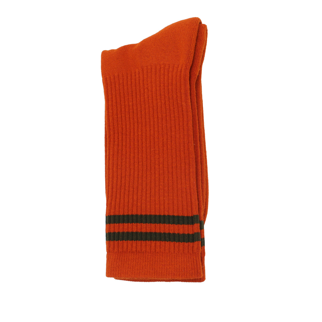 Orange sock with green stripes on a white background