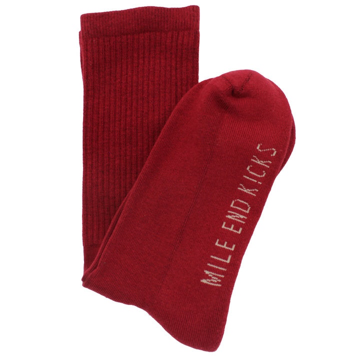 Red socks with 'Mile End Kicks' text on a white background