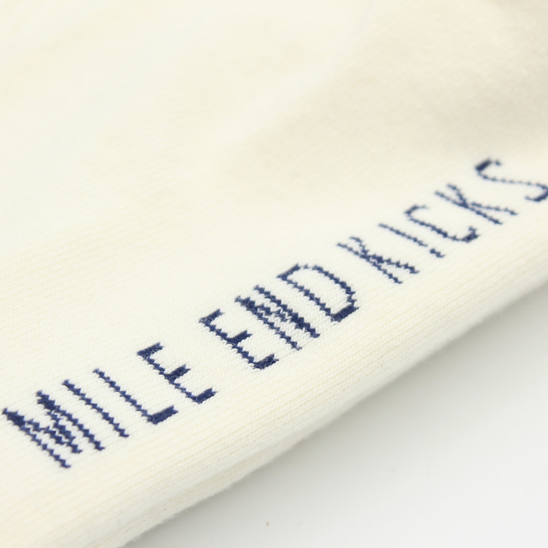 White sock with blue text 'MILE END KICKS' on a white background