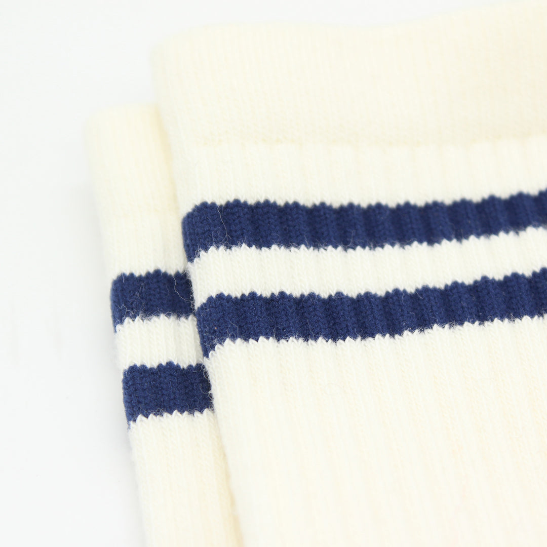 Close-up of white socks with blue stripes on a light background