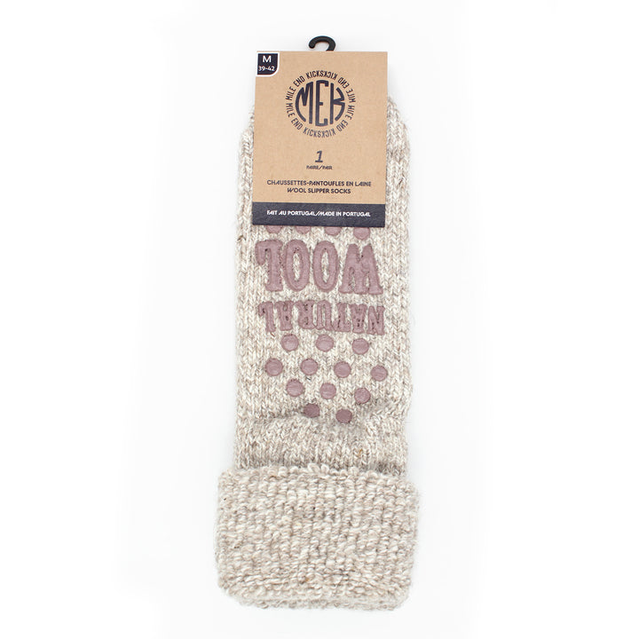 A pair of wool slipper socks with 'MEK' branding and the text '100% recycled lambswool'. The socks are white heather and a print design.
