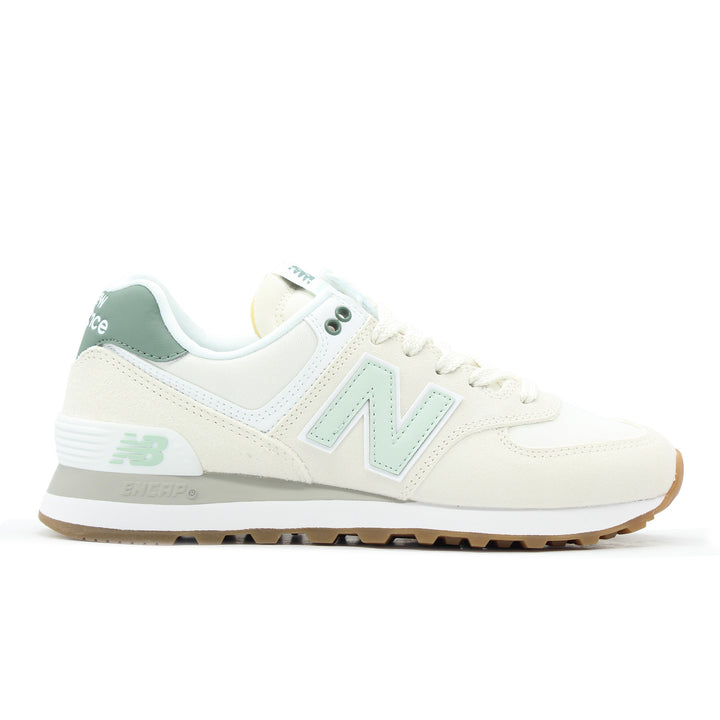 A white and green sneaker with suede and mesh.
