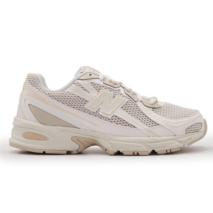 Beige and white running shoe on a white background.