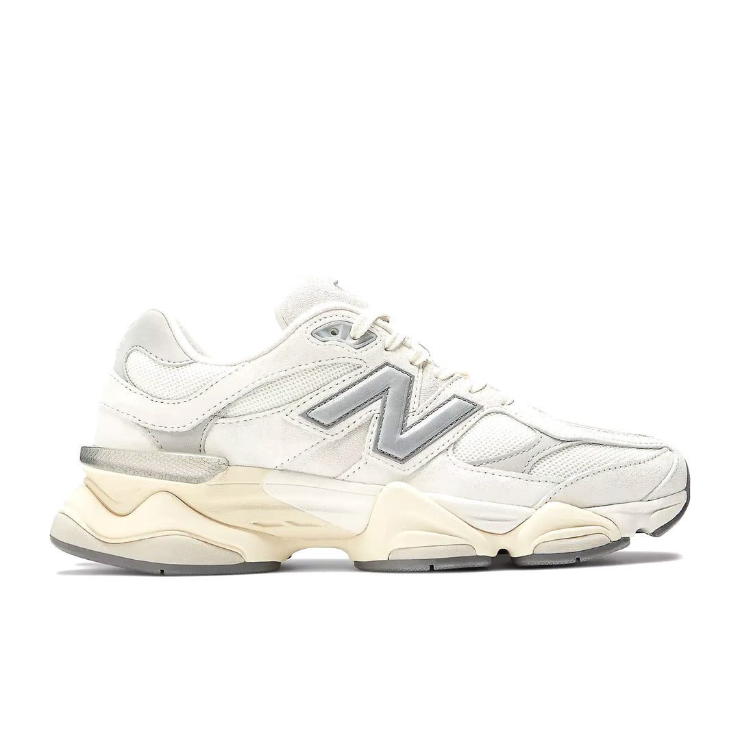 A white and grey New Balance sneaker.
